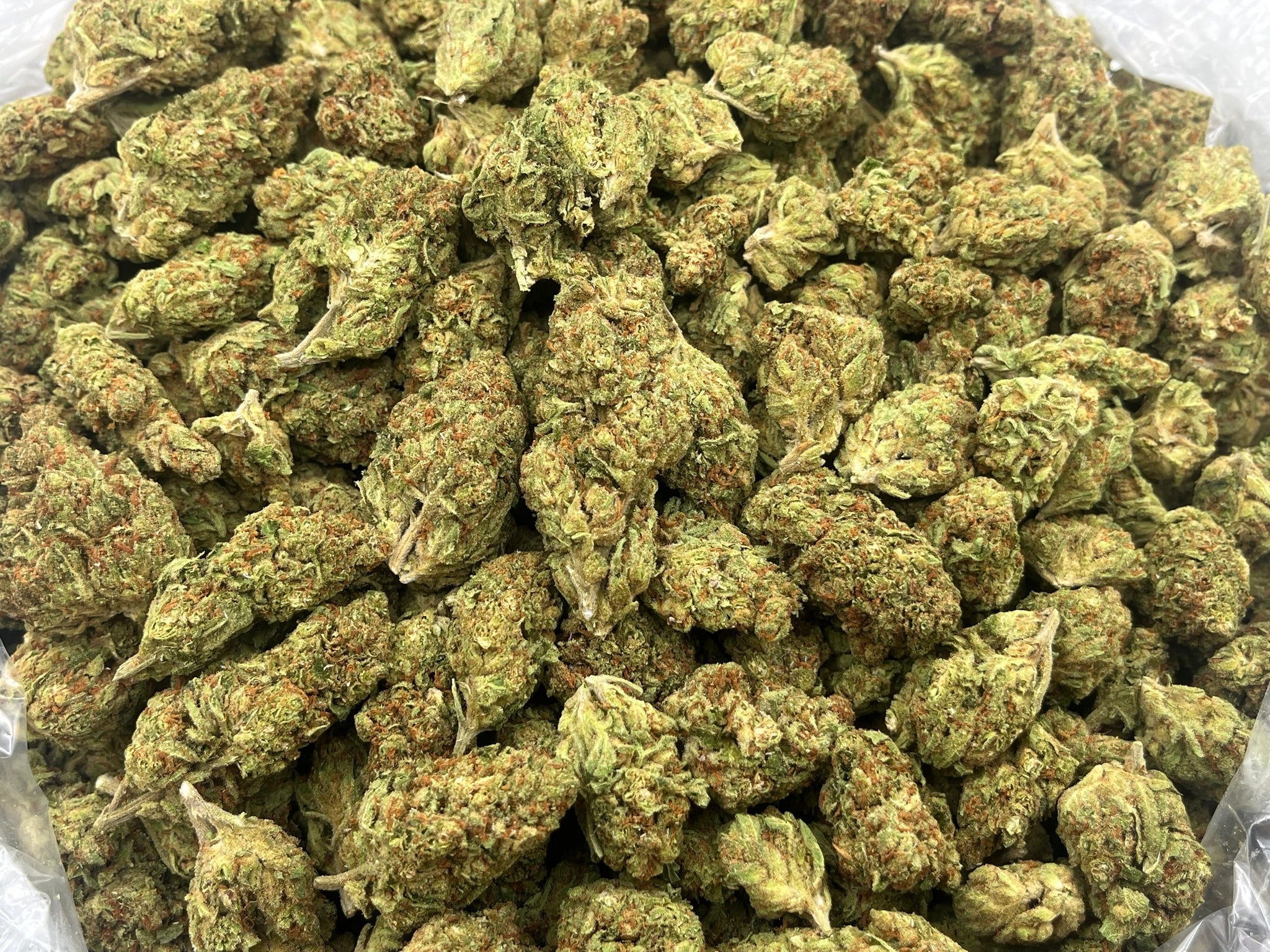 Green Crack THCA Flower dense bright green nugs with orange hairs